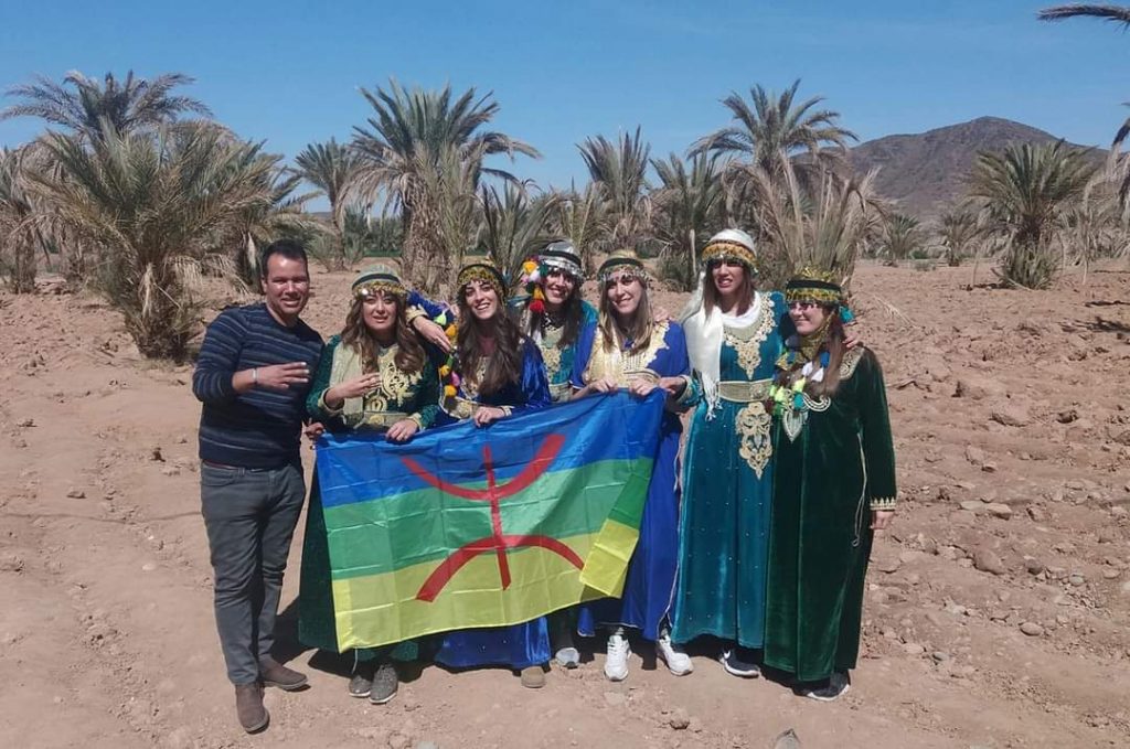 Mr Mohamed with a group of clients all dressed with local clothes.